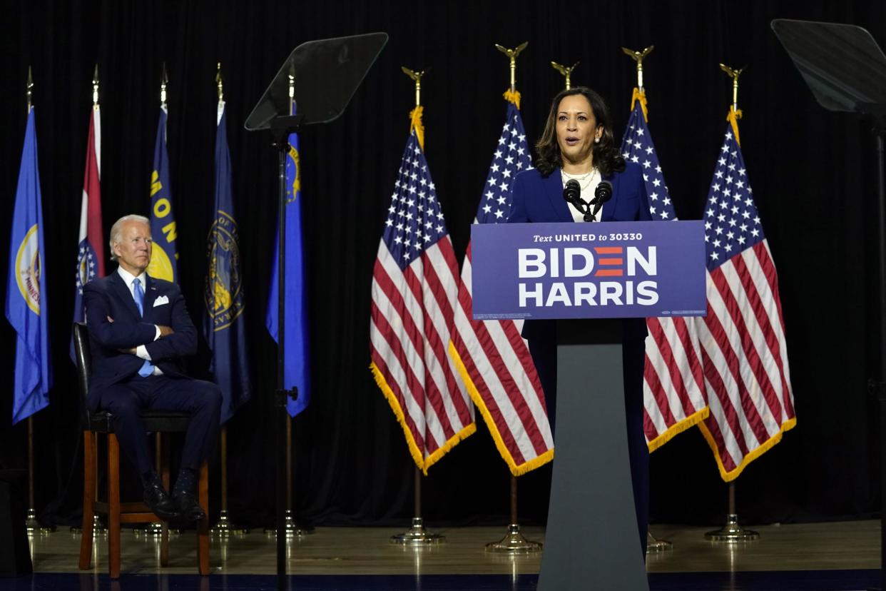 Democratic presidential candidate former Vice President Joe Biden listens as his running mate Senator Kamala Harris, speaks during a campaign event at Alexis Dupont High School in Wilmington, Delaware: AP Photo/Carolyn Kaster