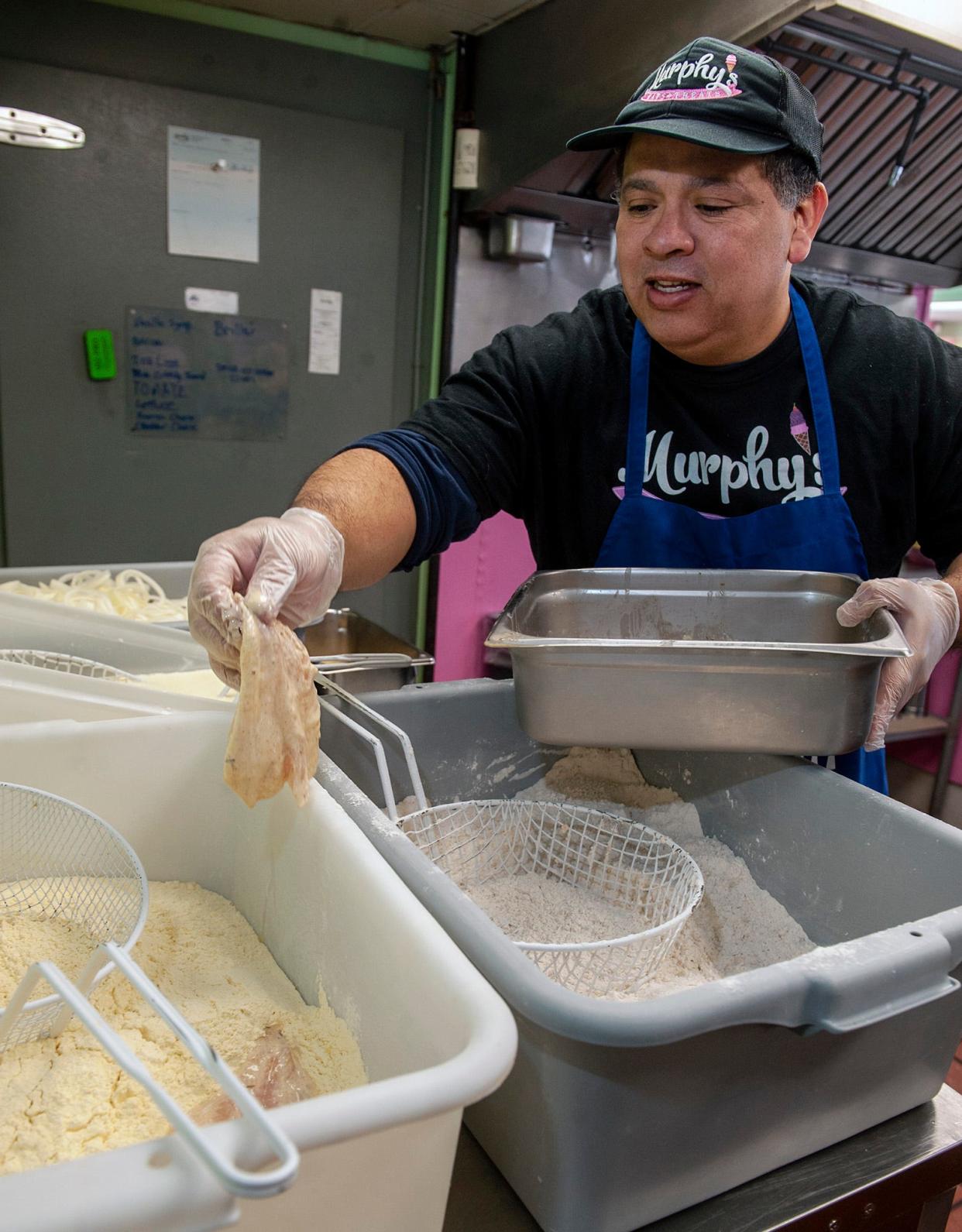 Chef Ronald Sotomayor prepares haddock for the fisherman's platter at Murphy's Eats & Treats on Edgell Road in Framingham, Feb. 21, 2024.