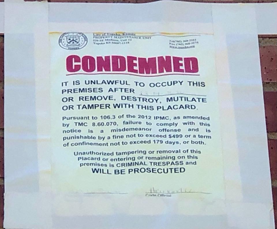 A flyer bearing the word "condemned" in red letters can be seen on the exterior of the former church building at 625 S.W. Polk.