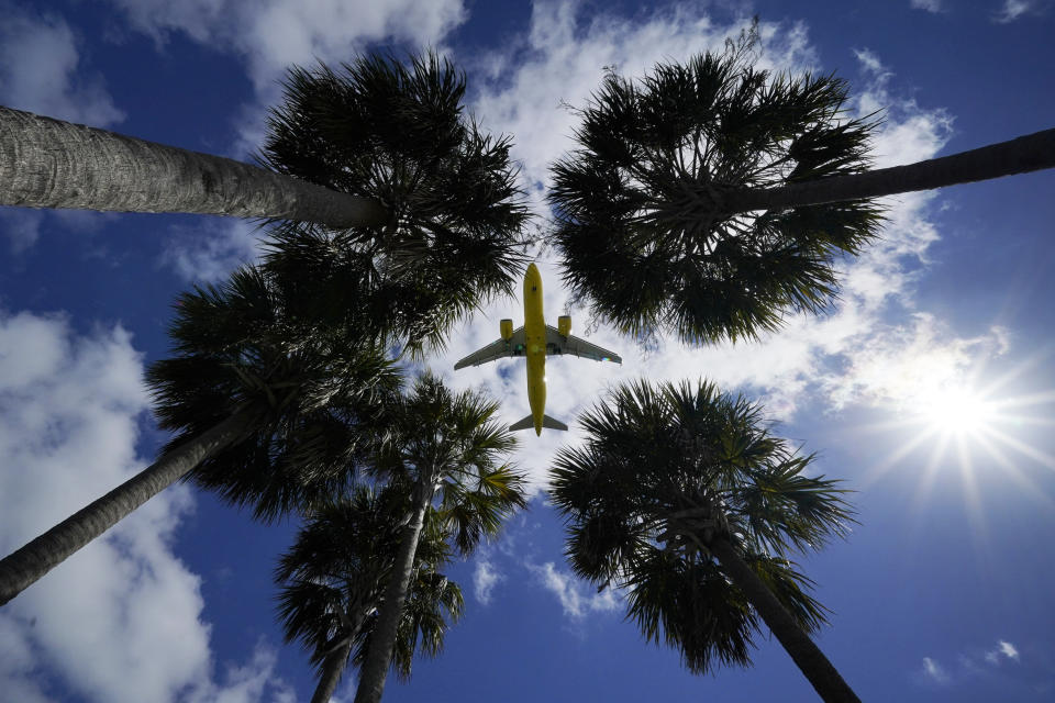 FILE - In this Friday, March 19, 2021 file photo, an airliner lands at Tampa International Airport in Tampa, Fla. On Sunday, March 21, more than 1.5 million people streamed through U.S. airport security checkpoints, the largest number since the pandemic tightened its grip on the United States more than a year ago. However, passenger traffic remains far below 2019 levels. (AP Photo/Gene J. Puskar)