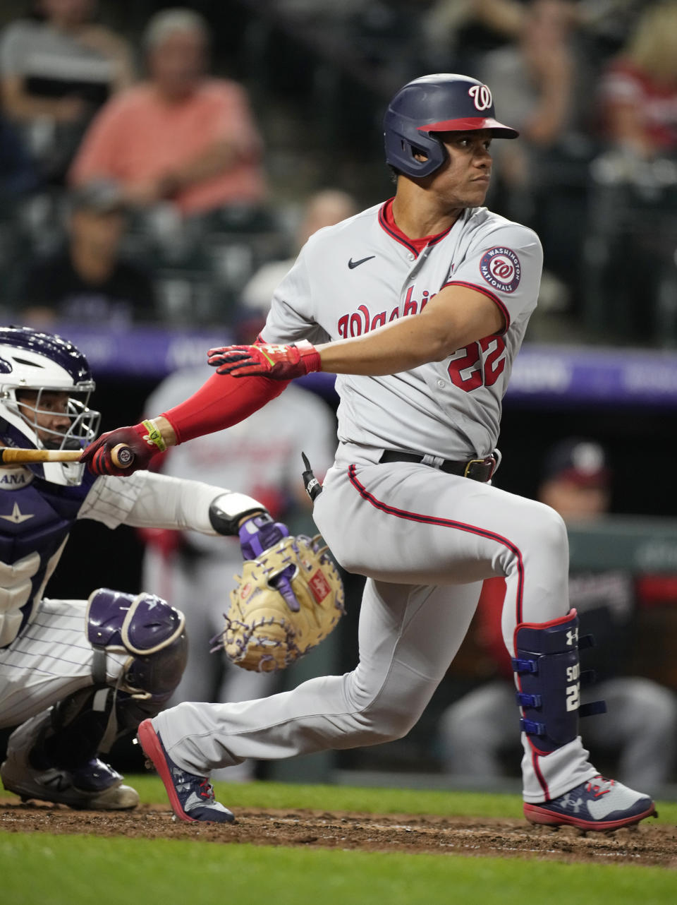 Washington Nationals' Juan Soto hits into a force play but drives in a run against Colorado Rockies starting pitcher German Marquez in the fifth inning of a baseball game Monday, Sept. 27, 2021, in Denver. (AP Photo/David Zalubowski)