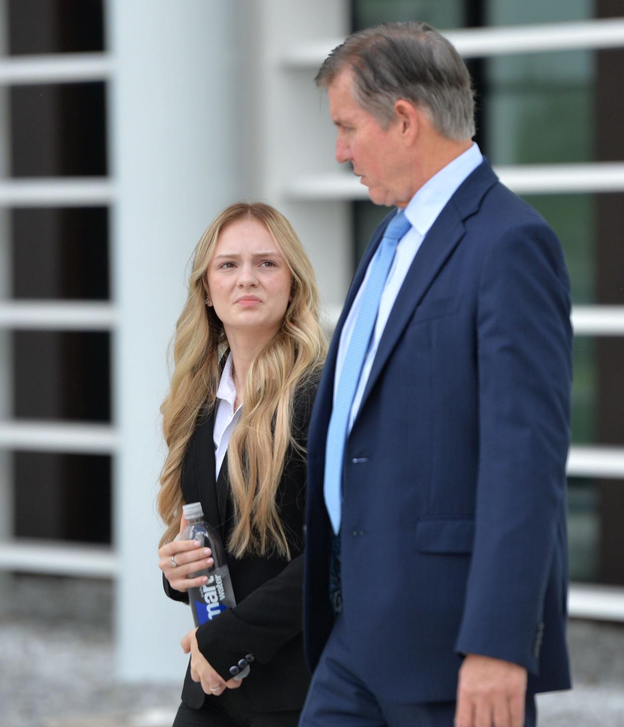 Maya Kowalski speaks with her attorney Greg Anderson, Thursday, after the first day of the Kowalski family's civil lawsuit against Johns Hopkins All Children's Hospital at the South County Courthouse in Venice, Florida.