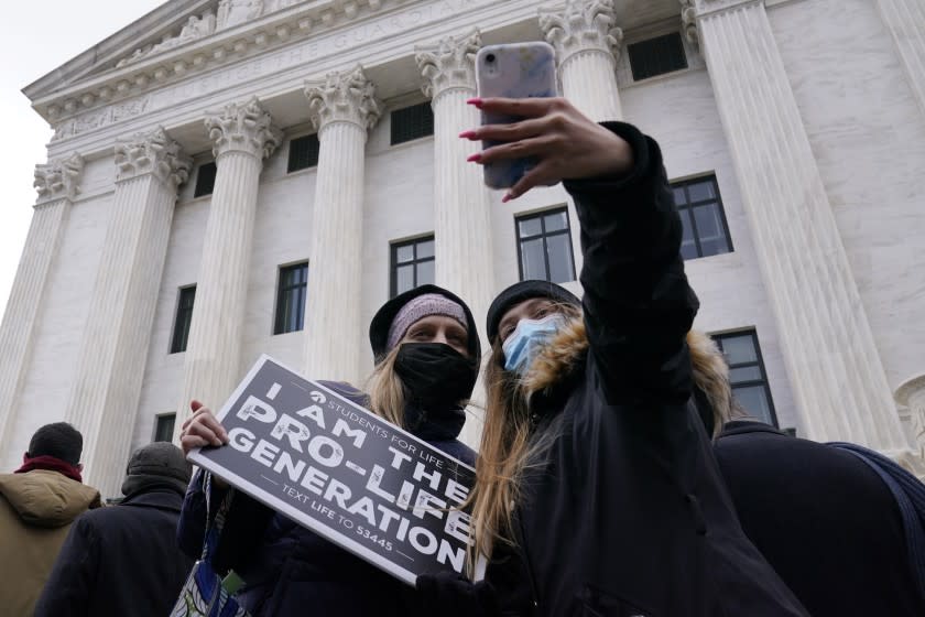 Andrea Albury, left, and her daughter Ella Albury, 15, both from Lynchburg, Va., take a selfie with the back of the Supreme Court as they participate in the 48th Annual March for Life in Washington, Friday, Jan. 29, 2021. (AP Photo/Susan Walsh)