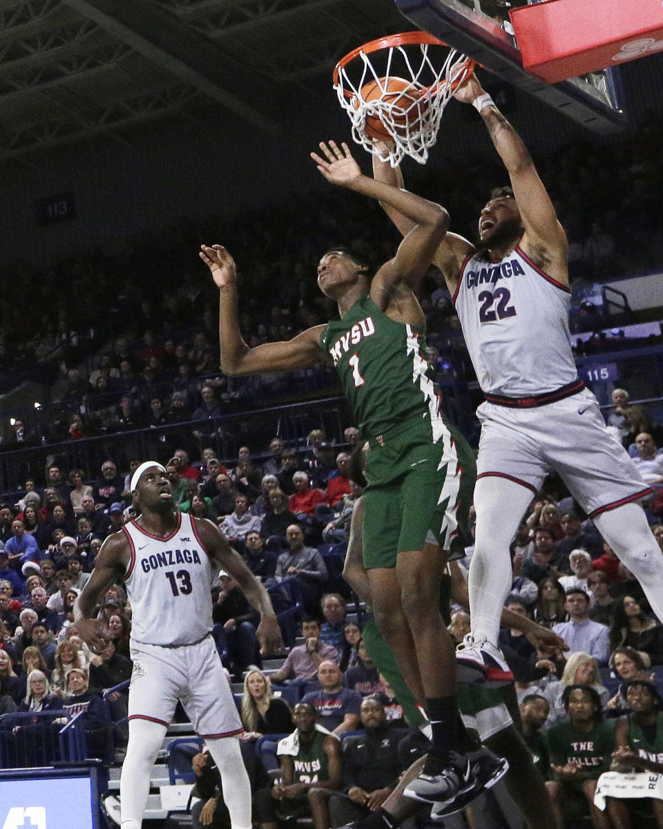 Gonzaga forward Anton Watson (22) dunks next to Mississippi Valley State guard Chidi Umeh (1) during the first half of an NCAA college basketball game, Monday, Dec. 11, 2023, in Spokane, Wash. (AP Photo/Young Kwak)