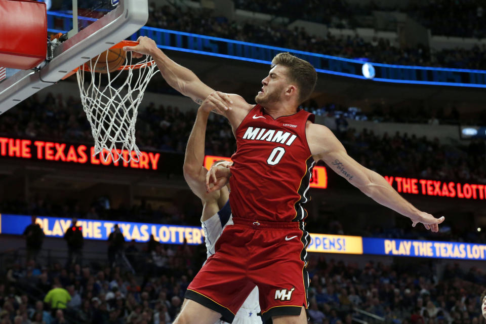 FILE - In this Dec. 14, 2019, file photo, Miami Heat forward Meyers Leonard (0) dunks on Dallas Mavericks forward Kristaps Porzingis, obscured at rear, during the first half of an NBA basketball game in Dallas. Jusuf Nurkic is back and healthy. So are Zach Collins, Meyers Leonard, Giannis Antetokounmpo, Anthony Davis and plenty of others. If the four-month NBA shutdown had a silver lining, it’s that a lot of ailing players got well. (AP Photo/Michael Ainsworth, File)