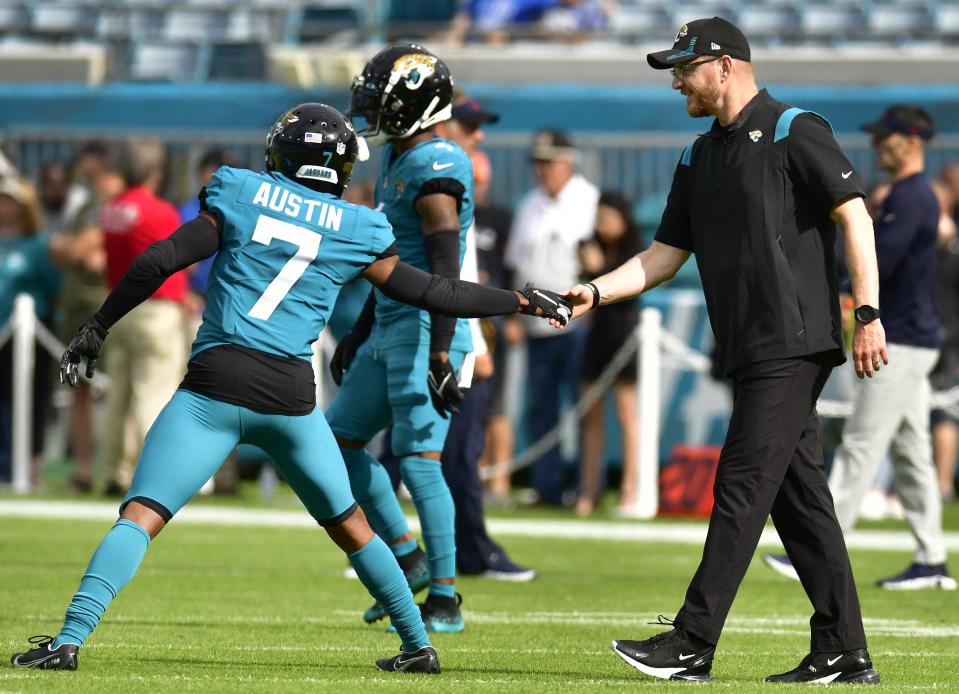Jaguars interim head coach Darrell Bevell shakes hands with receiver Tavon Austin during warmups before a Dec. 19 game.