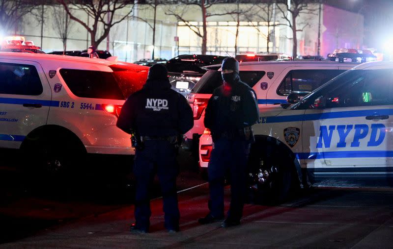 Emergency personnel respond at the scene where NYPD officers were shot while responding to a domestic violence call