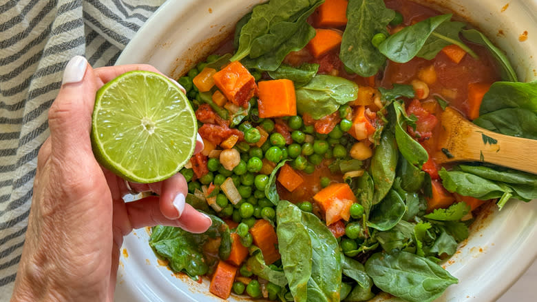 hand adding lime to slow cooker