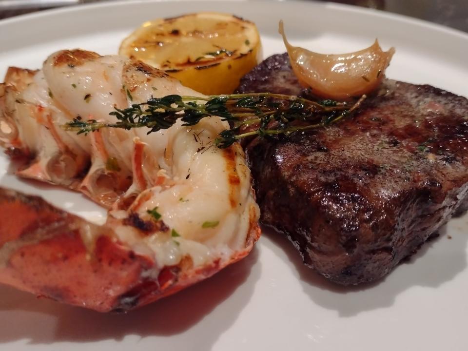 A surf and turf plate with steak and a lobster tail.