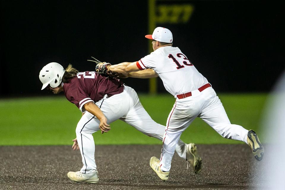 Iowa City High pitcher Gable Mitchell tags out Dowling Catholic's Caden Sanders during a Class 4A high school semifinal state baseball game Thursday at Duane Banks Field in Iowa City.
