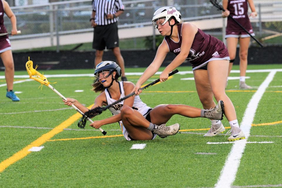 Boca Raton's Katie Ward goes for a challenging pass from the ground during the first half of Tuesday's regional semifinal action against Stoneman Douglas (Apr. 25, 2023).