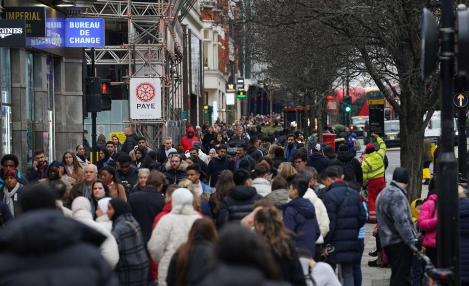 Shoppers on Oxford Street (PA)