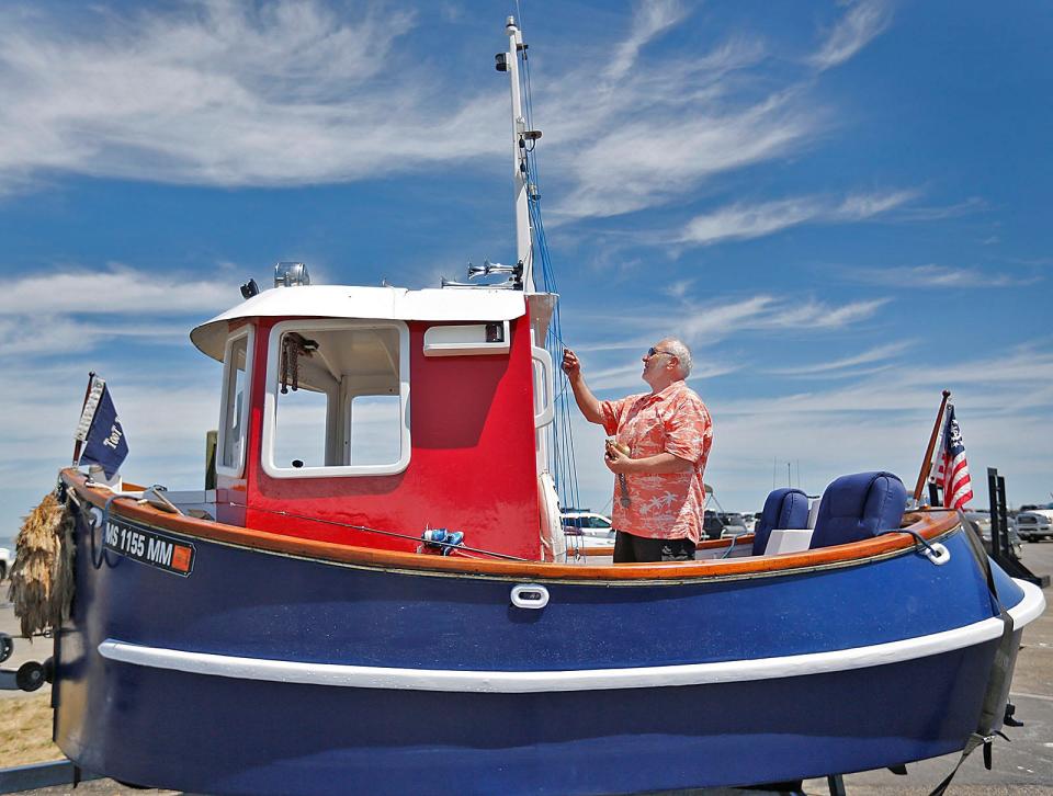 Mike Magnant, of Middleboro, with his 14-foot tugboat named Toot Toot.