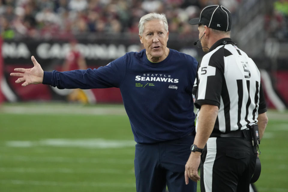 Seattle Seahawks head coach Pete Carroll argues a call with side judge Jim Quirk (5) in the first half of an NFL football game against the Arizona Cardinals Sunday, Jan. 7, 2024, in Glendale, Ariz. (AP Photo/Rick Scuteri)