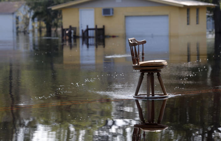 <p>A stool sits in the middle of a roadway in floodwaters in the aftermath of Hurricane Florence in Nichols, S.C., Friday, Sept. 21, 2018. Virtually the entire town is flooded and inaccessible except by boat, just two years after it was flooded by Hurricane Matthew. (Photo: Gerald Herbert/AP) </p>