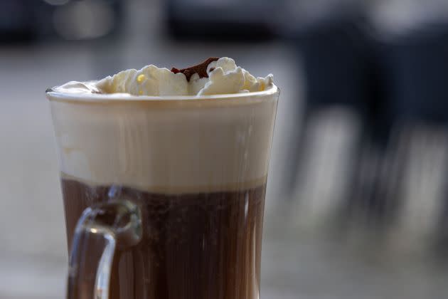 Hot Irish coffee with Irish whiskey, which has been topped with cream