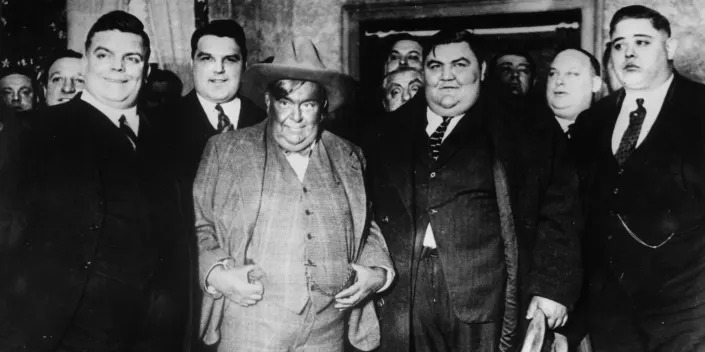 Fat Men's club members line up for a photo taken circa 1930