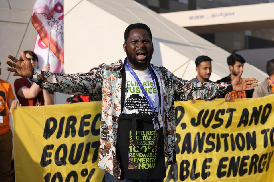 People participate in a demonstration for a just and equitable transition from fossil fuels at the COP28 U.N. Climate Summit, Tuesday, Dec. 5, 2023, in Dubai, United Arab Emirates. (AP Photo/Kamran Jebreili)