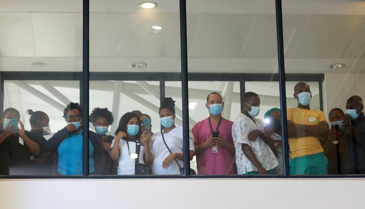 Health care workers look through a window at a hospital in Khayelitsha, Cape Town, South Africa during the rollout of the first batch of Johnson and Johnson vaccines in the country. South African President Cyril Ramaphosa was among the first in his country to receive a COVID-19 vaccination to launch the inoculation drive.