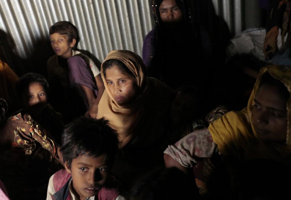 FILE - In this Dec. 2, 2016 file photo, Rohingya from Myanmar who recently crossed over to Bangladesh, huddle in a room at an unregistered refugee camp in Teknaf, near Cox's Bazar, a southern coastal district about, 296 kilometers (183 miles) south of Dhaka, Bangladesh. Muslim villagers in western Myanmar's troubled Rakhine state said Sunday, Jan. 15, 2017, that they hope positive change will result from a U.N. envoy's visit to the region, where soldiers are accused of widespread abuses against minority Muslims, including murder, rape and the burning of thousands of homes. (AP Photo/A.M. Ahad, File)