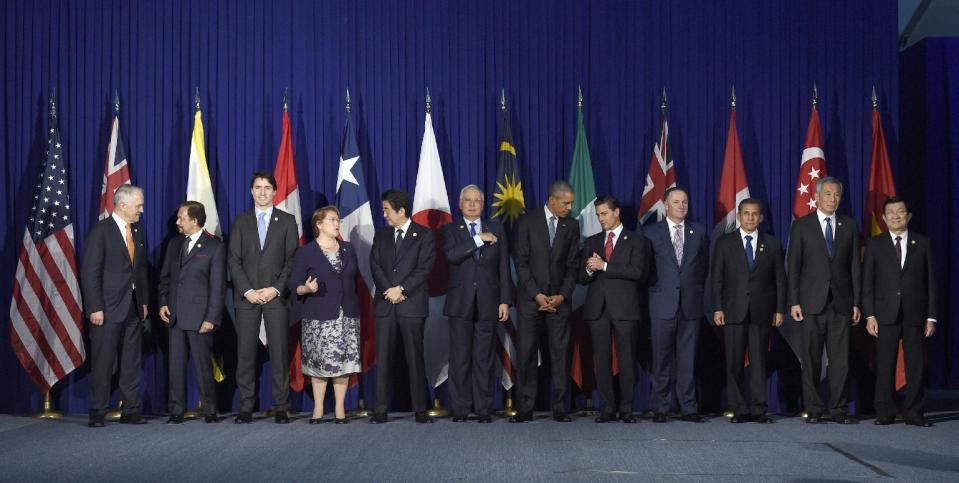 FILE - In this Nov. 18, 2015 file photo, U.S. President Barack Obama, center right, and other leaders of the Trans-Pacific Partnership countries pose for a photo in Manila, Philippines, ahead of the start of the Asia-Pacific Economic Cooperation summit. Several countries expressed hope Tuesday, Jan. 24, 2017, that the TPP could be salvaged, after President Donald Trump's decision on a U.S. withdrawal from the trade pact left its future in serious jeopardy. The leaders are, from left, Australia's Prime Minister Malcolm Turnbull, Brunei's Sultan Hassanal Bolkiah, Canada's Prime Minister Justin Trudeau, Chile's President Michelle Bachelet, Japan's Prime Minister Shinzo Abe, Malaysia's Prime Minister Najib Razak, Obama, Mexico's President Enrique Pena Nieto, New Zealand's Prime Minister John Key, Peru's President Ollanta Humala Tasso, Singapore's Prime Minister Lee Hsien Loong, and Vietnam's President Truong Tan Sang. (AP Photo/Susan Walsh, File)