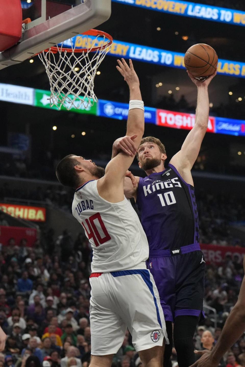 Sacramento Kings center Domantas Sabonis (10) dunks the ball against Los Angeles Clippers center Ivica Zubac (40) in the second half Sunday, Feb. 25, 2024, at Crypto.com Arena in Los Angeles. Kirby Lee/USA TODAY Sports