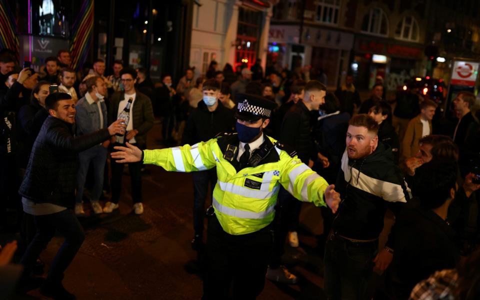 Policeman among crowds in Soho - Reuters