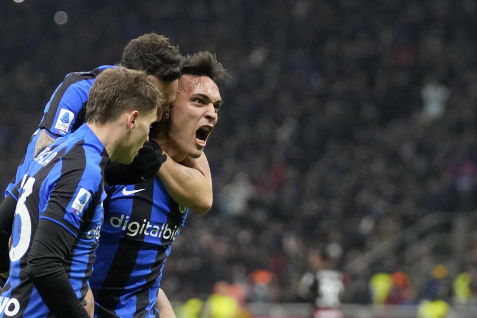 Inter Milan's Lautaro Martinez, right, celebrates with teammates after scoring his side's opening goal during the Serie A soccer match between Inter Milan and AC Milan at the San Siro Stadium, in Milan, Italy, Sunday, Feb. 5, 2023. (AP Photo/Antonio Calanni)