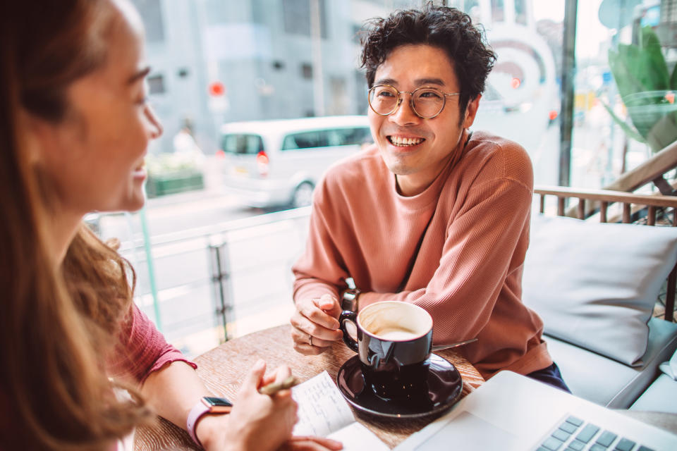 a man and a woman tlking over coffee