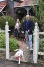 Australia's Prime Minister-elect Anthony Albanese, right, and his partner Jodie Haydon go for a walk with their dog, Toto, in Sydney, Sunday, May 22, 2022. Albanese has promised to rehabilitate Australia's international reputation as a climate change laggard with steeper cuts to greenhouse gas emissions. (Dean Lewins/AAP Image via AP)