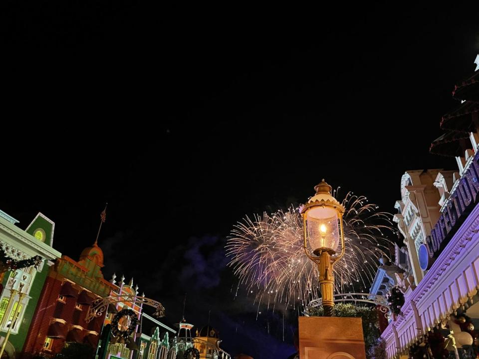 Fireworks behind a lamp post in Disney World.