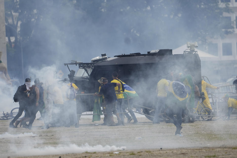 FILE - Protesters, supporters of Brazil's former President Jair Bolsonaro, attack a police armored vehicle as they storm the Planalto Palace in Brasilia, Brazil, Sunday, Jan. 8, 2023. Planalto is the official workplace of the president of Brazil. (AP Photo/Eraldo Peres, File)