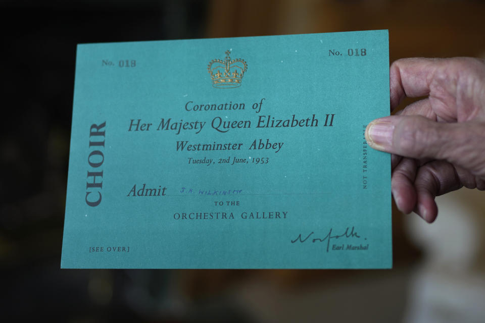 James Wilkinson displays his invitation for Queen Elizabeth II's coronation where he performed as a Westminster Abbey chorister on June 2, 1953, during an interview in London, April 17, 2023. The choristers spent months preparing for the service, learning the music and lyrics to the hymns they would sing during the three-hour long ceremony. Wilkinson knew he was part of something extraordinary, so the future BBC journalist recorded everything he saw, in a looping script on the now-yellowed pages of his diary. (AP Photo/Kin Cheung)