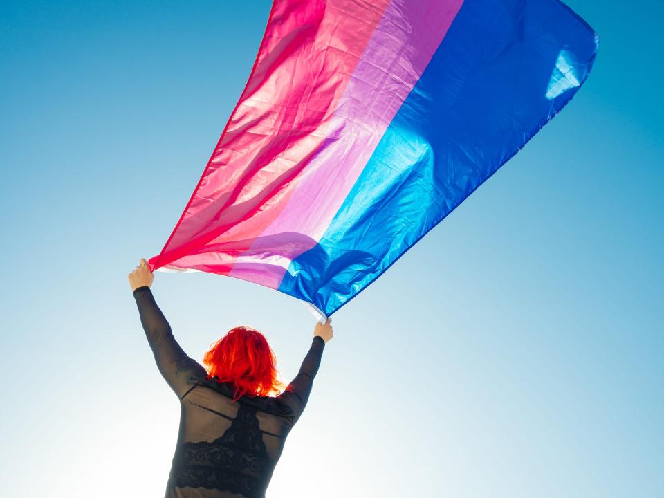 Woman holding bisexual pride flag