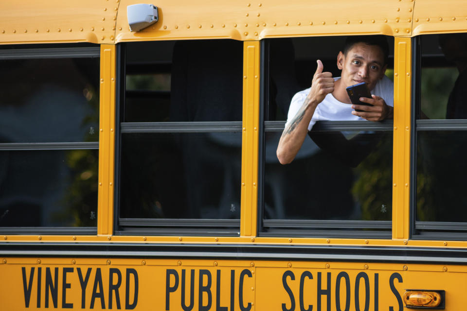 A man, who is part of a group of immigrants that had just arrived, flashes a thumbs up Wednesday Sept. 14, 2022, in Edgartown, Mass., on Martha's Vineyard. Florida Gov. Ron DeSantis on Wednesday flew two planes of immigrants to Martha's Vineyard, escalating a tactic by Republican governors to draw attention to what they consider to be the Biden administration's failed border policies. (Ray Ewing/Vineyard Gazette via AP)