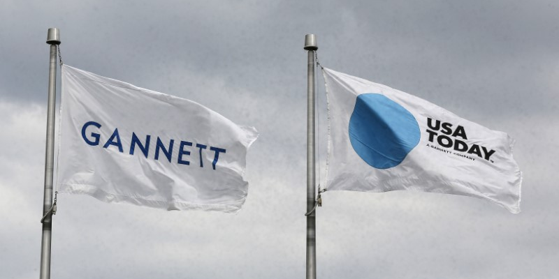 The corporate flags for the Gannett Co and its flagship newspaper, USA Today, fly outside their corporate headquarters in McLean, Virginia, July 23, 2013.    REUTERS/Larry Downing 