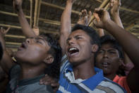 Rohingya refugees shout slogan during a protest against the repatriation process at Unchiprang refugee camp near Cox's Bazar, in Bangladesh, Thursday, Nov. 15, 2018. The head of Bangladesh's refugee commission said plans to begin a voluntary repatriation of Rohingya Muslim refugees to their native Myanmar on Thursday were scrapped after officials were unable to find anyone who wanted to return. (AP Photo/Dar Yasin)