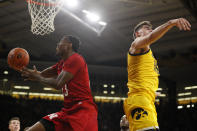 Nebraska guard Jervay Green drives to the basket past Iowa center Luka Garza, right, during the first half of an NCAA college basketball game, Saturday, Feb. 8, 2020, in Iowa City, Iowa. (AP Photo/Charlie Neibergall)