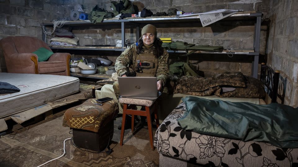 A Ukrainian frontline paramedic uses a Starlink internet connection in a basement living quarters as Russian shells land nearby above ground on February 20, 2023 in the Donbas region of eastern Ukraine. - John Moore/Getty Images