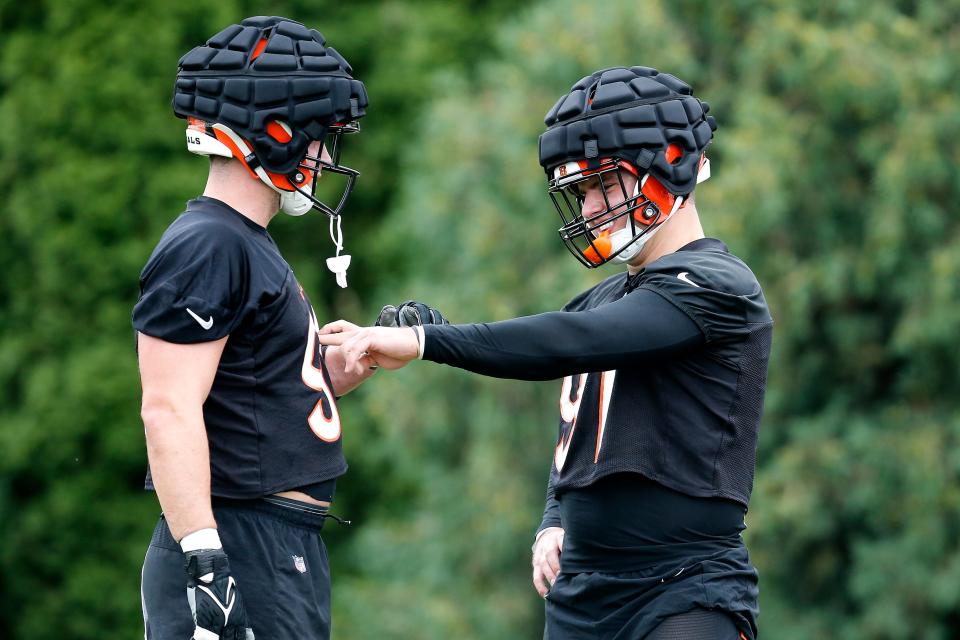 Cincinnati Bengals defensive ends Sam Hubbard (94) and Trey Hendrickson (91) face off in a drill during the first day of preseason training camp at the Paul Brown Stadium training facility in downtown Cincinnati on Wednesday, July 27, 2022.