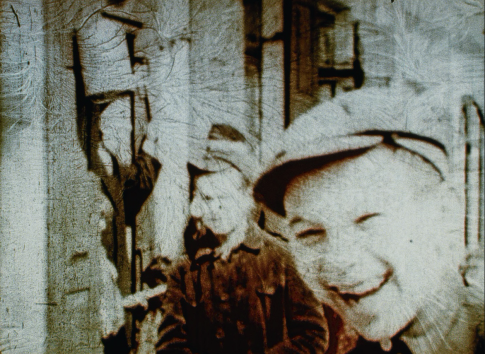 A smiling boy seen in 1938 archival footage in 'Three Minutes - A Lengthening'