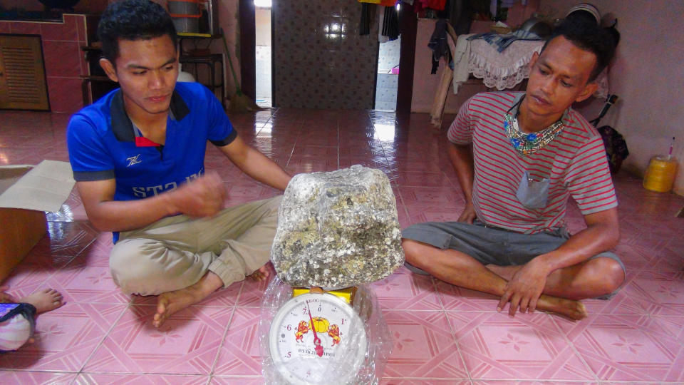 Asaree Pooad, 24, and his dad with one of the ambergris lumps. Source: Newsflash/Australscope
