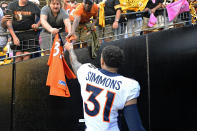 Denver Broncos free safety Justin Simmons (31) hands his gloves to a fan after an NFL football game against the Pittsburgh Steelers in Pittsburgh, Sunday, Oct. 10, 2021. The Steelers won 27-19. (AP Photo/Don Wright)