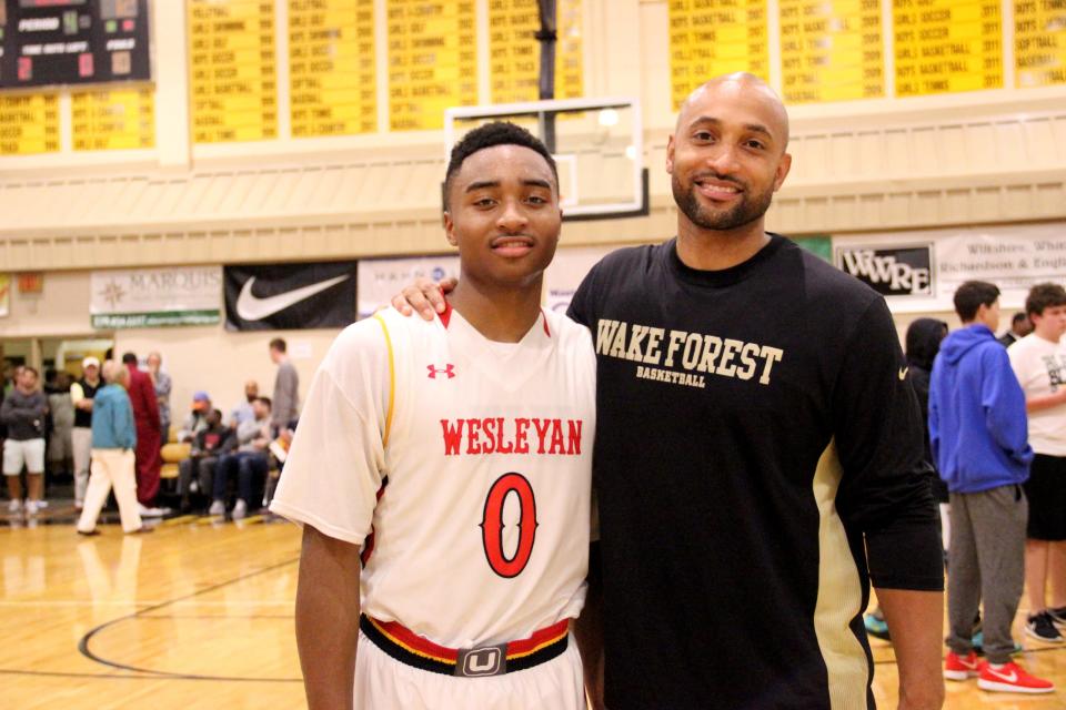 Brandon Childress, left, poses for a photo with his father, Randolph Childress, after Wesleyan Christian's victory over Whitney Young in a game played in 2014.