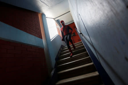Moises Vazquez, 26, known as Spider-Moy, a computer science teaching assistant at the Faculty of Science of the National Autonomous University of Mexico (UNAM), who teaches dressed as a comic superhero Spider-Man, walks down the stairs on his way to work in Iztapalapa neighbourhood, in Mexico City, Mexico, May 27, 2016. REUTERS/Edgard Garrido
