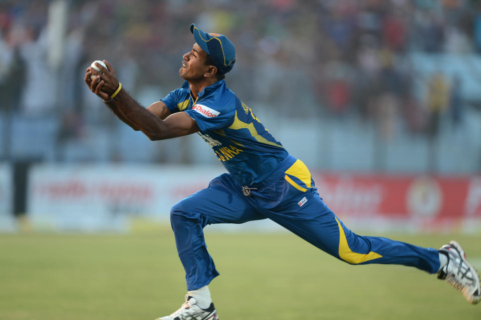 Sri Lankan cricketer Nuwan Kulasekara takes the catch to dismiss Bangladesh batsman Shakib Al Hasan during the second T20 cricket match between Bangladesh and Sri Lanka at The Zahur Ahmed Chowdhury Stadium in Chittagong on February 14, 2014. AFP PHOTO/ Munir uz ZAMAN