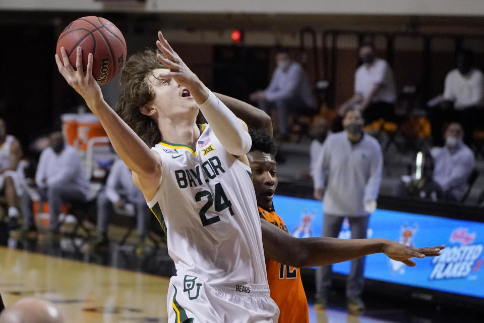 Baylor guard Matthew Mayer (24) shoots in front of Oklahoma State forward Matthew-Alexander Moncrieffe, right, in the first half of an NCAA college basketball game Saturday, Jan. 23, 2021, in Stillwater, Okla. (AP Photo/Sue Ogrocki)