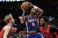 Philadelphia 76ers guard Kelly Oubre Jr. (9) drives between Toronto Raptors' Kobi Simmons (8) and Gradey Dick (1) during the second half of an NBA basketball game Sunday, March 31, 2024, in Toronto. (Frank Gunn/The Canadian Press via AP)
