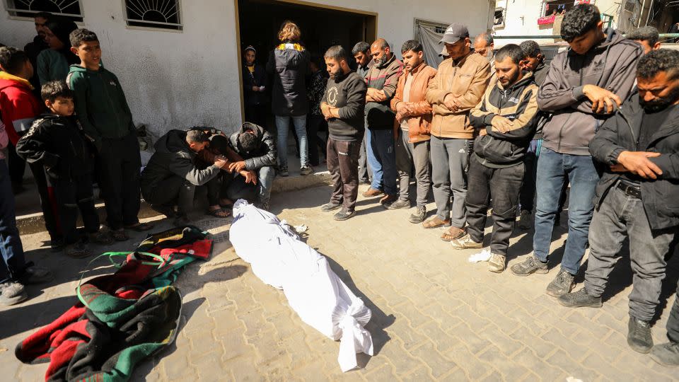 Palestinians mourn near a body at Kamal Edwan Hospital in Beit Lahia, northern Gaza, on February 29, after Israeli soldiers allegedly opened fire at Gaza residents who rushed towards trucks loaded with aid. - AFP/Getty Images