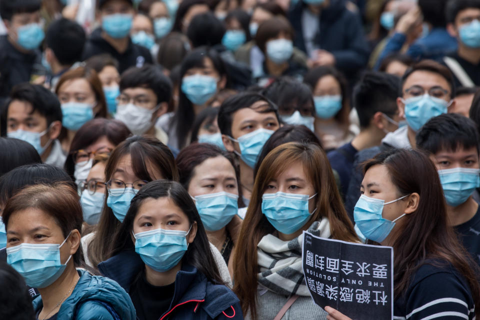 Medical workers wearing protective masks gather during a protest outside the Hospital Authority's head office in Hong Kong, China, on Feb. 4, 2020. | Paul Yeung/Bloomberg via Getty Images